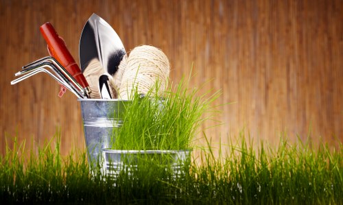 Gardener performing seasonal maintenance on a small terrace garden